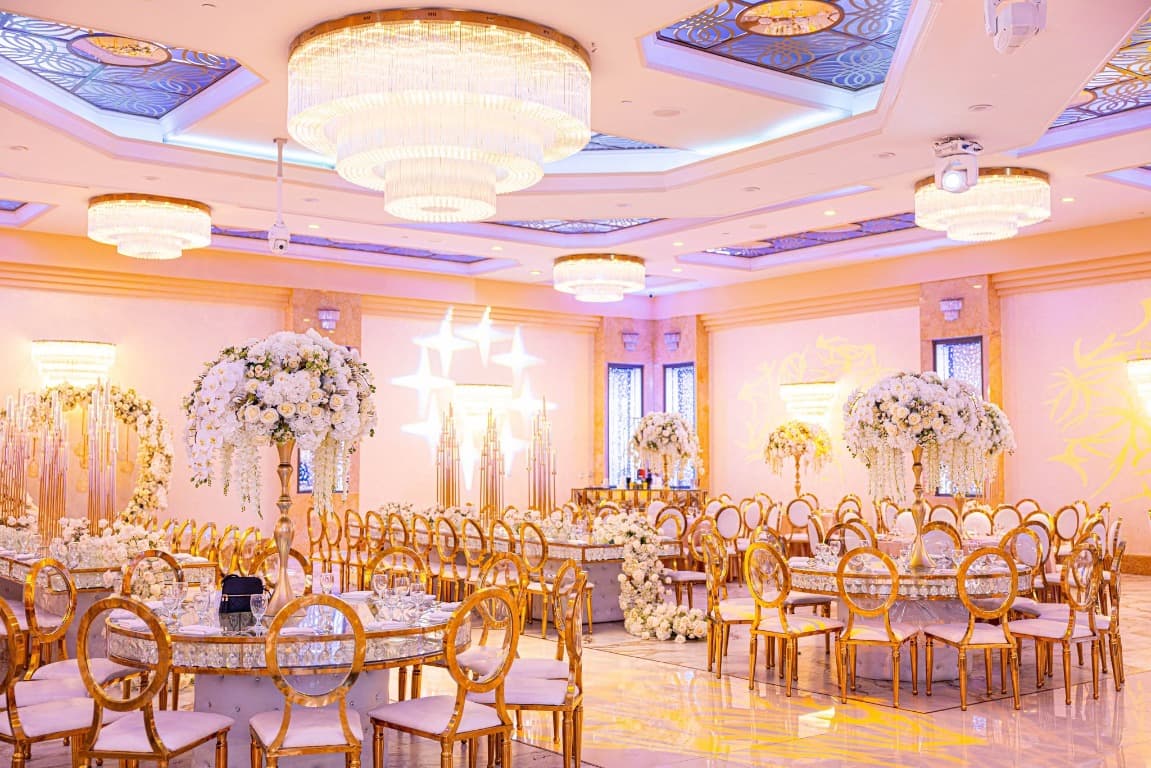 Decorated ballroom with chandeliers and floral arrangements